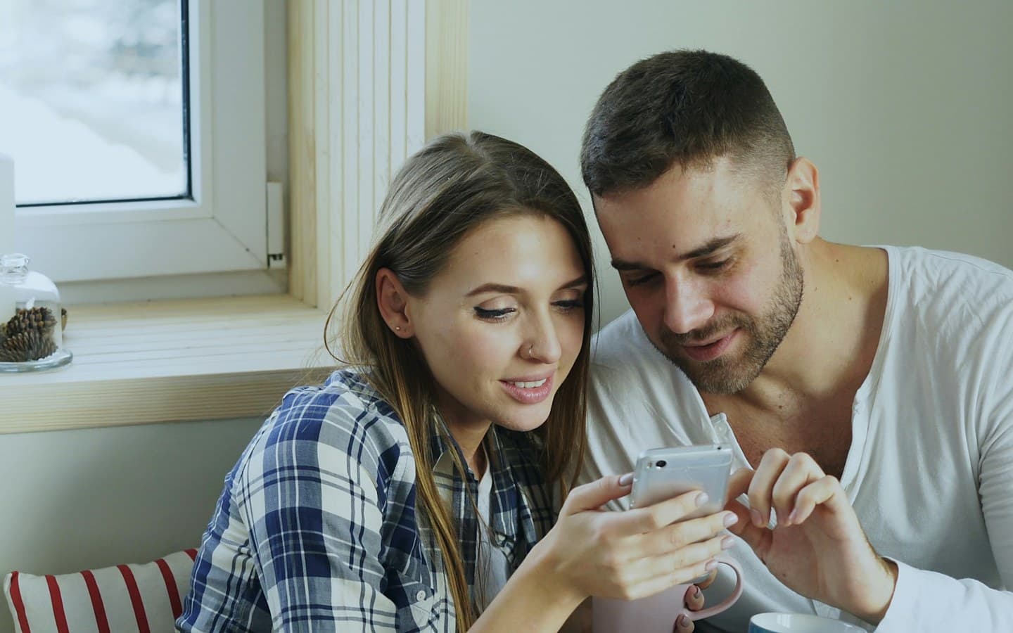 Two people looking at a phone together